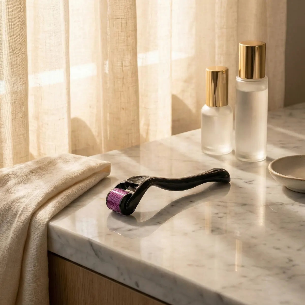 Skincare roller and bottles on a marble counter with soft lighting